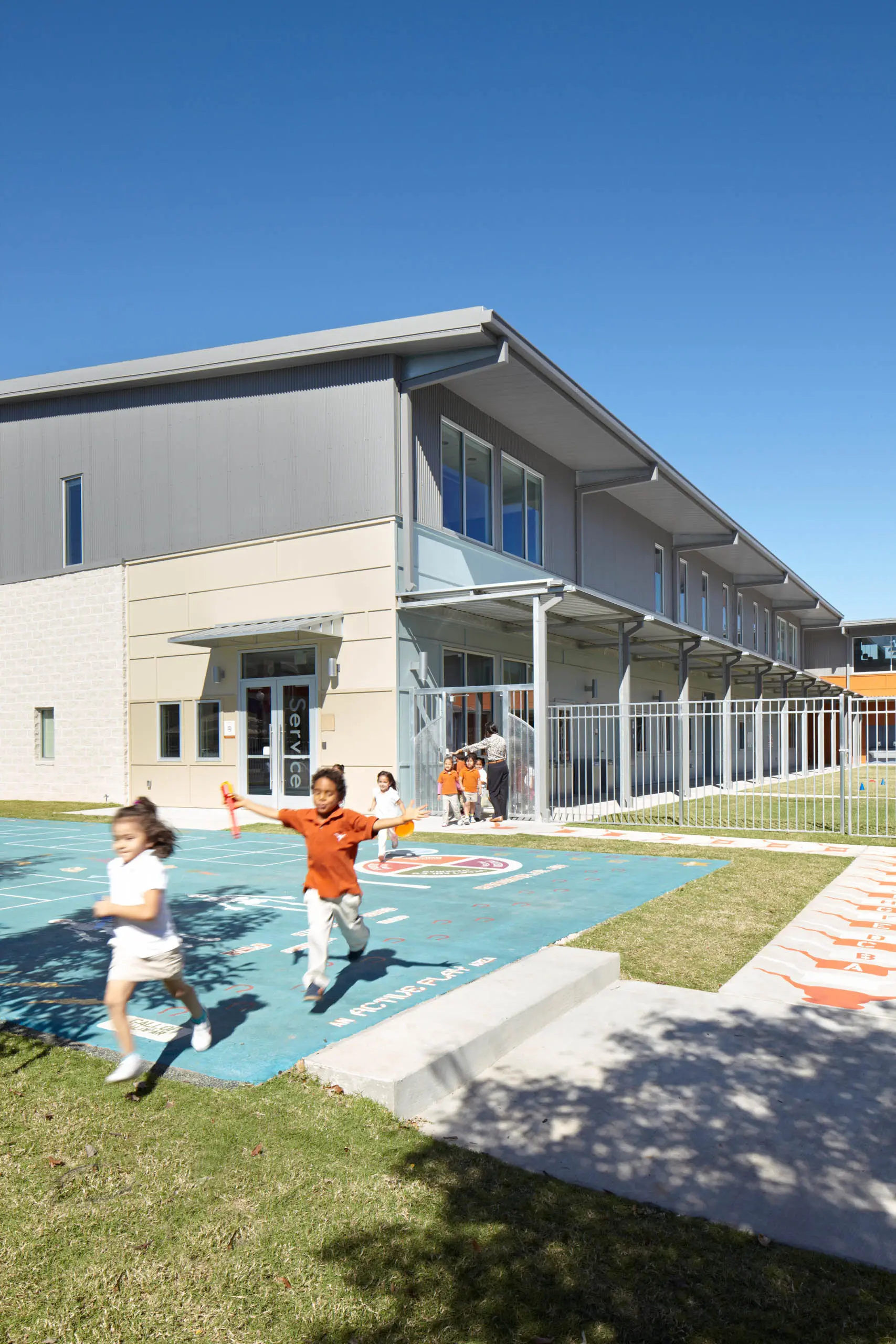 Kids running in front of the UT Elementary Charter School